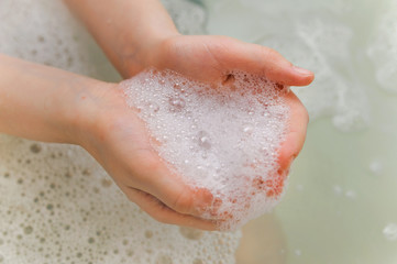 Fototapeta premium soap foam with bubble in a hands