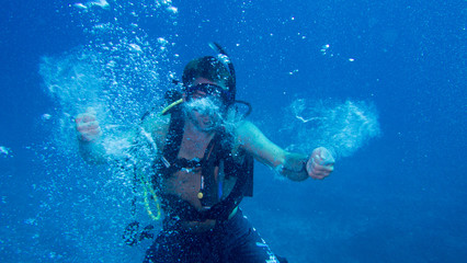 Fototapeta na wymiar Scuba diver making bubbles underwater