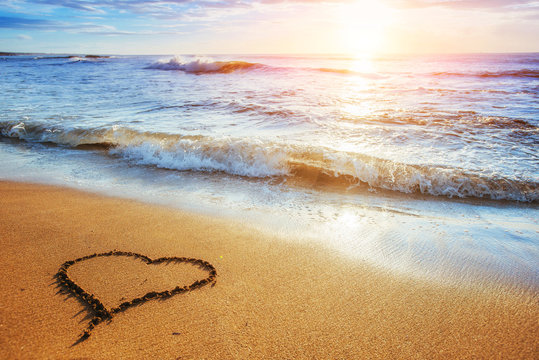 Heart on the sand beach. Romantic composition.