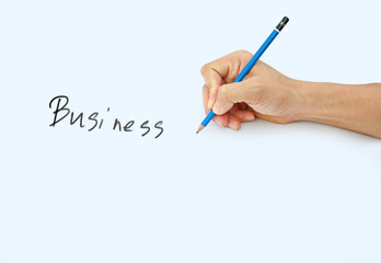 Hand holding a pencil on a white paper background, writing with pencil for word " Business "