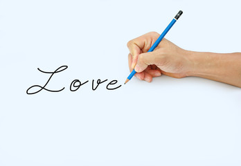 Hand holding a pencil on a white paper background, writing with pencil for word " Love "
