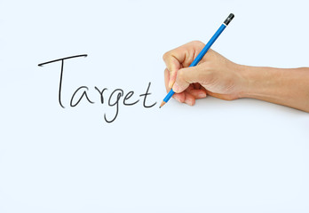 Hand holding a pencil on a white paper background, writing with pencil for word " Target "