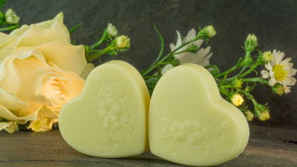 Yellow roses on a background of schifer with chocolate hearts