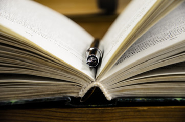 Open book and fountain pen