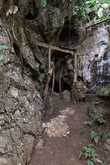 Secret door of cave entrance, holy buddhist sanctuary in jungle in middle of nowhere