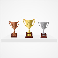 Winners podium with gold, silver and bronze cups. 