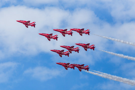 Shuttle Roll being performed under a blue sky by the Red Arrows