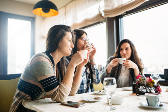 Female friends enjoy in coffee at cafe bar