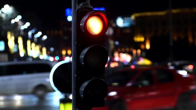 Traffic light in busy streets intersection at night time lapse video
