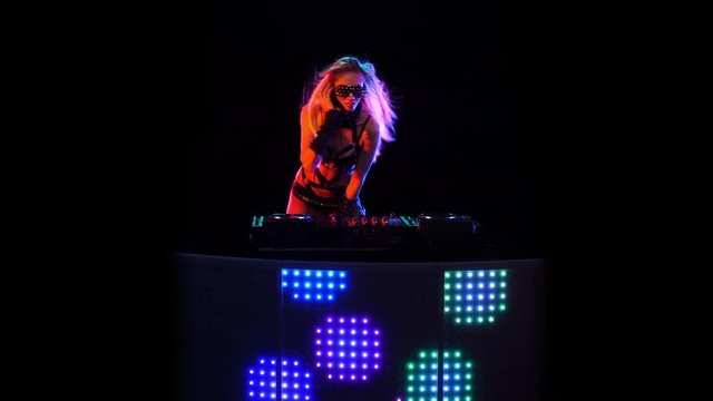 Sexy blonde girl DJ playing on vinyl in slow motion