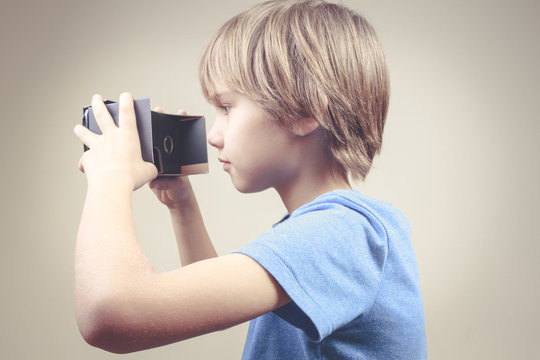 Child Using Black 3D VR Cardboard Glasses