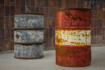 The old and rusty barrel against a wall
