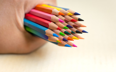 Man holding colour pencils in hand