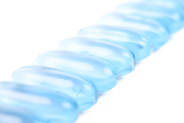 Line of multiple softgel pills isolated