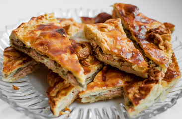 Chunks of fish cake lie on a glass plate. Close-up.