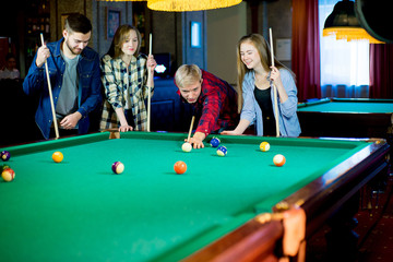 Fototapeta premium friends playing billiard