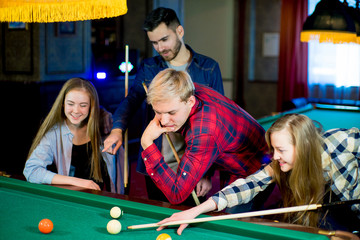 friends playing billiard