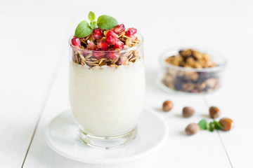 Fresh granola with vanilla cream with pomegranate and mint