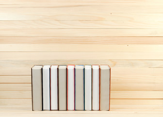 Stack of hardback books on wooden table. Back to school. Copy space