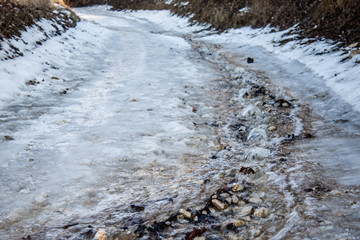 Steep inclimb with melting icy snow in forest