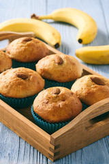 Naklejka na ściany i meble Sweet banana muffins with almond on blue wooden table.