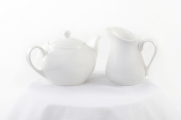 White milk jug and a teapot