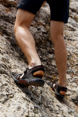 Guy climbs on rock mountains
