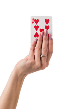 Female hand showing nine hearts card