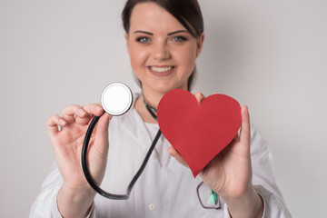 doctor holding hearth and stethoscope 