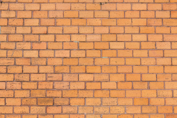 Fototapeta premium orange farbene Ziegelsteinwand