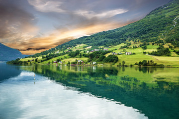 Fototapeta na wymiar rural lake landscape, Norway, Olden, green hills seaside. fjord