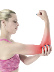 Acute pain in a woman elbow. Female holding hand to spot of elbo