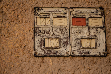 Old historic street number plate of house in sunset light