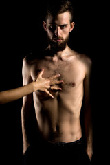 Fototapeta premium slim bearded man with thin bare torso isolated on black