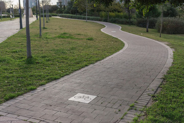 cycleway sign road with curves, bikeway for cyclists only. Bike lane in the Turia River gardens in Valencia Spain