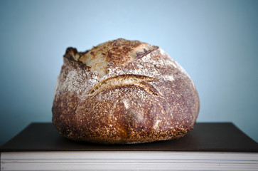 Loaf of sourdough bread on the book