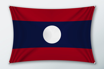 Laos national flag. Symbol of the country on a stretched fabric with waves attached with pins. Realistic vector illustration.