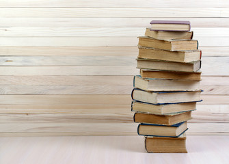 Stack of hardback books on wooden table. Back to school.