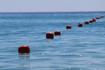 fila di boe rosse in mezzo al mare