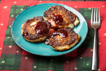 cheese pancake with jam on a plate