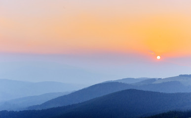 Thick fog and sunrise in the mountains. Carpathians. Ukraine. Eu