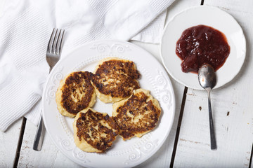 cheese pancake with jam on a plate