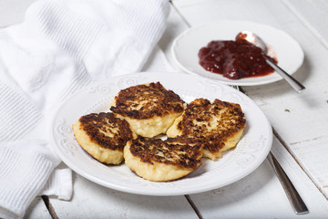 cheese pancake with jam on a plate