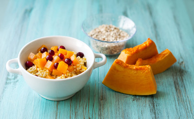 Porridge with pumpkin and vitamin smoothies for breakfast. On a wooden background
