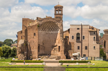 The Roman Forum is a plaza surrounded by many ruins of ancient government buildings in the center of Rome