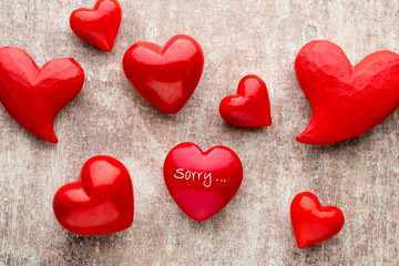 Red heart on the wooden background.