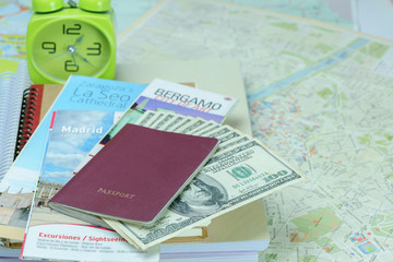 Traveling concept : Passport , books , city map and U.S dollar bills