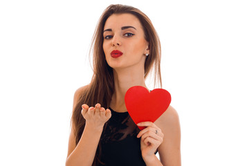 young charming woman with red lips preparing to celebrate valentines day with heart symbol in studio isolated on white background