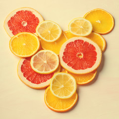 Fototapeta na wymiar Citrus fruit Heart from slices of lemon, orange, grapefruit on white background. Love, healthy, ecology concept.