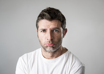 Obraz premium man with blue eyes sad and depressed looking lonely and suffering depression feeling sorrow
